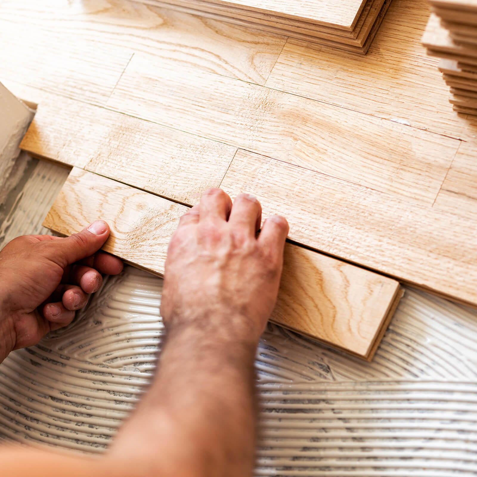 Man installing hardwood | Custom Floors